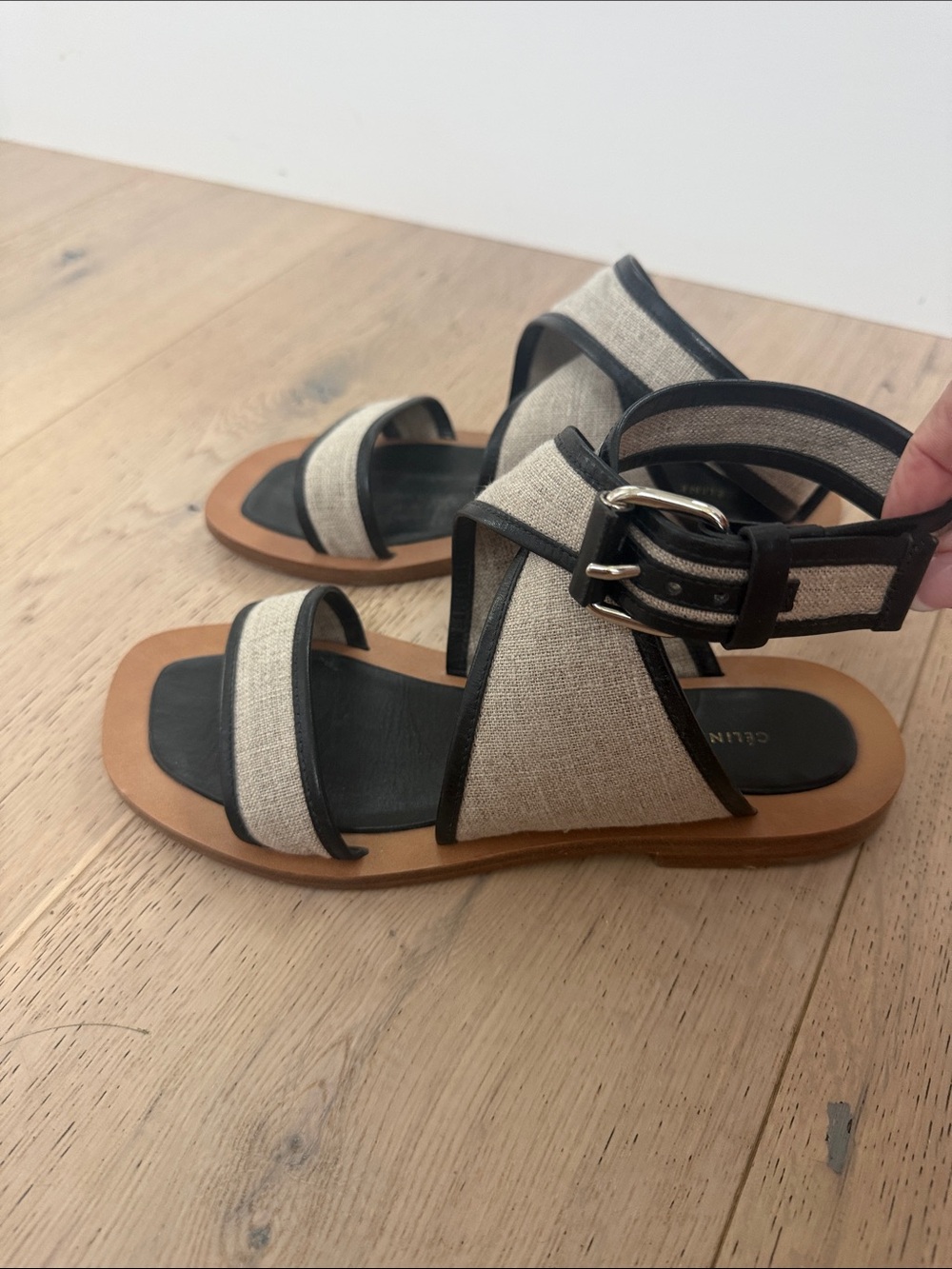 Celine sandals featuring a distinct square toe and beige canvas straps with blac